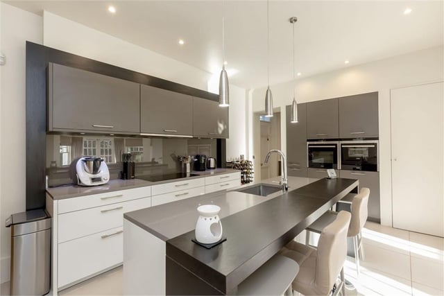 The bespoke kitchen has Silestone worktops, integrated Siemens appliances including induction hob and combination steam oven, Liebherr wine fridge, Gaggenau coffee machine and tiling by Porcelanosa.