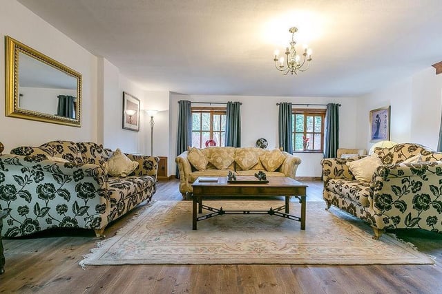 Moving inside the cottage, the hub is this large and well-proportioned sitting room. It boasts a log burner and a set of beautiful French doors that lead to a side courtyard.