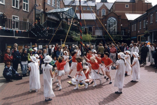 Children from Reignhead Primary School, Beighton, entertain shoppers in Orchard Square with traditional Maypole dancing in May 1992