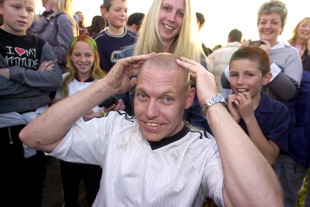 Postal worker Alan Spear, aged 35, of Wheatley Hills, shows off his shaved head. Cash raised from the sponsored event in 2001 helped to fund a holiday for terminally-ill postman John Grimes and his family