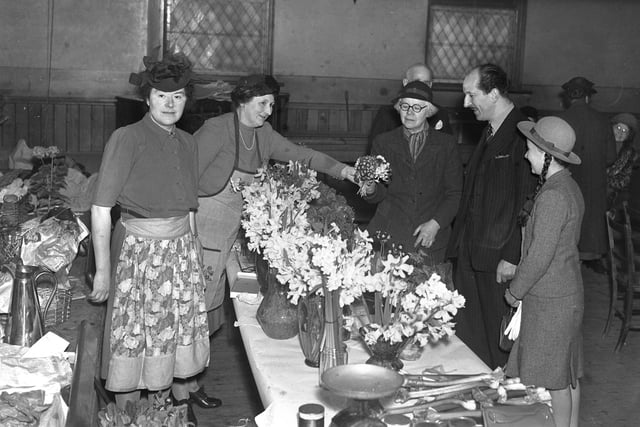 Admiring the spring flowers on a stall at Sunderland's Women's Conservative Association bring and buy sale in 1945. Days later, war would end in Europe.