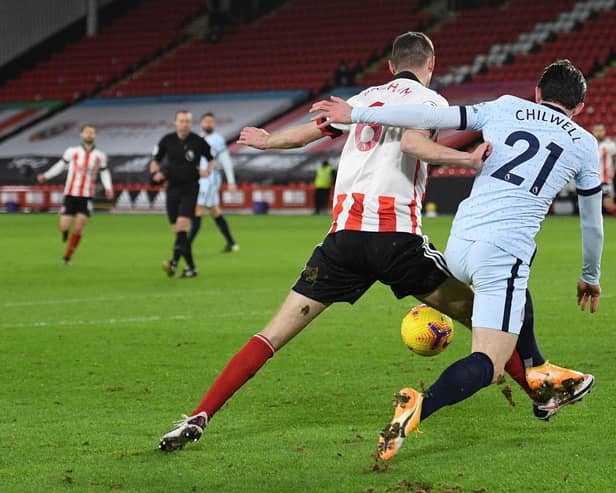 Sheffield United's English defender Chris Basham (C) is fouled by Chelsea's English defender Ben Chilwell (R) but the penalty was not given after a VAR review (Photo by OLI SCARFF/POOL/AFP via Getty Images)