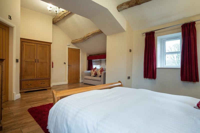 The master bedroom is fitted with wooden floorboards, exposed beams and benefits from an ensuite shower room.