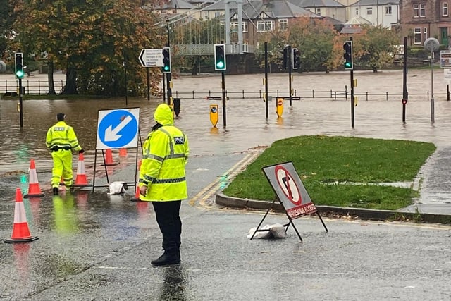An image from Police Scotland reporting that the River Nith in Dumfries has burst its banks and flooded Whitesands.