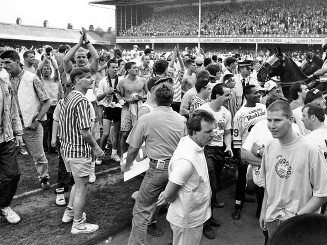 United fans celebrate on the pitch at Leicester after a 5-2 win sealed promotion for Sheffield United to the first division, May 5, 1990