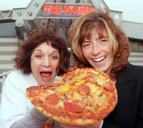 Staff at the the area's two sports Domes - The Doncaster Dome, and Barnsley's Metrodome - delivered a pizza to each other to raise money for Children in Need in 1998. Our picture shows Dome duty manager Shelley Armitgae (right) and the Metrodome's admin/finance officer tucking into one of the pizzas.