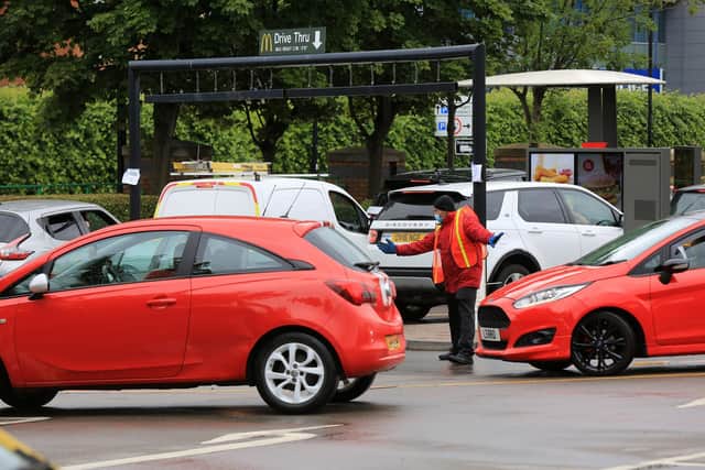 Staff directed the motorists at McDonald's on Attercliffe Common near Meadowhall which reopened today. Picture: Chris Etchells