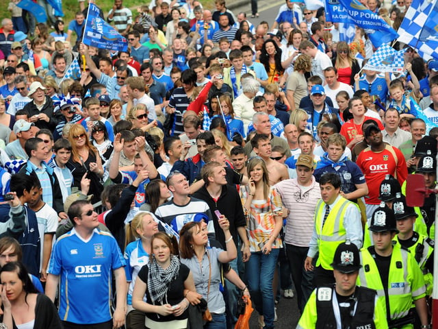 Fans get a great view walking alongside the Pompey bus, as it heads towards the seafront. Picture: Malcolm Wells 082236-5493