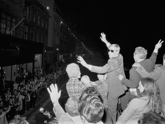Crowds turn out to cheer Scottish boxer Ken Buchanan as he waves from the bus taking him through Princes Street in Edinburgh in September 1971.