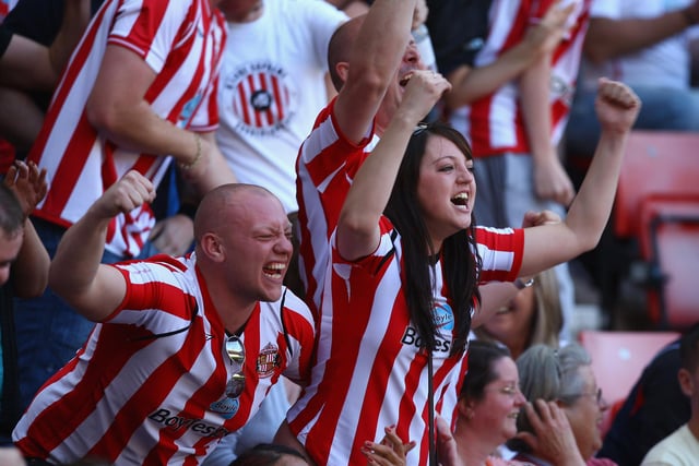 Sunderland fans react after hearing that Newcastle United are losing during the Barclays Premier League match between Sunderland and Chelsea at the Stadium of Light.