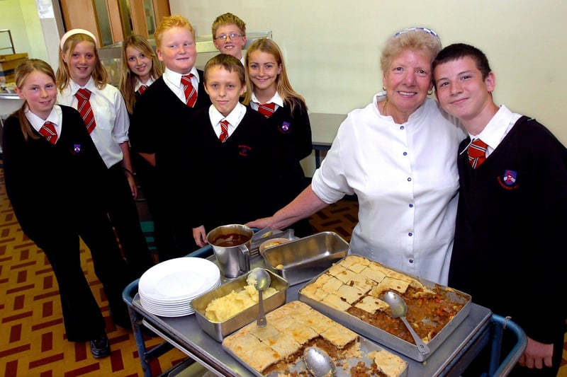 Hungerhill School dinner lady Beryl Lyall retired in 2006. Our picture shows her with grandson Keiran Lyall, aged 12, and pupils, from left, Kathryn Hope, Samantha Orridge, Sophie Morton, Kyle Betts, Adam Millward, Adam Jackson and Kathryn Payne, all aged 12.
