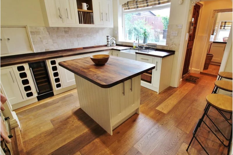The kitchen oozes country style with solid wood flooring and feature wood work tops.