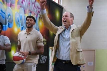 Tyrone Mings, left, with Prince William, at the Reach Up Youth project in Sheffield, shooting basketball hoops
