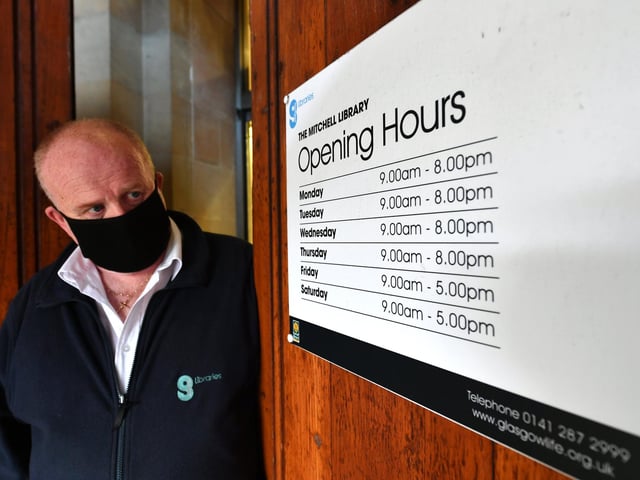 John McGregor about to change the opening hours sign to the new opening hours.