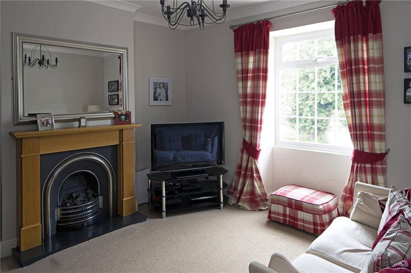 The lounge features an oak fire surround with cast iron inlay and coal-effect gas fire.