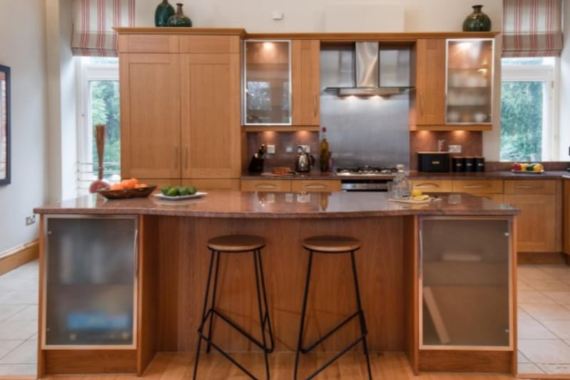 The kitchen features a breakfast bar for a morning snack.