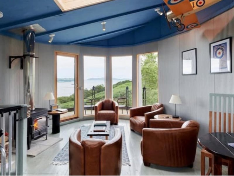 The living area features decadently squishy leather furniture.