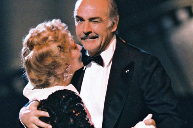 Scottish actor Sean Connery, President of 12th French Academy Cesar Awards, winks at the photographer while dancing 07 March 1987 in Paris witch French actress Jeanne Moreau, the annual French film Industry award ceremony. 