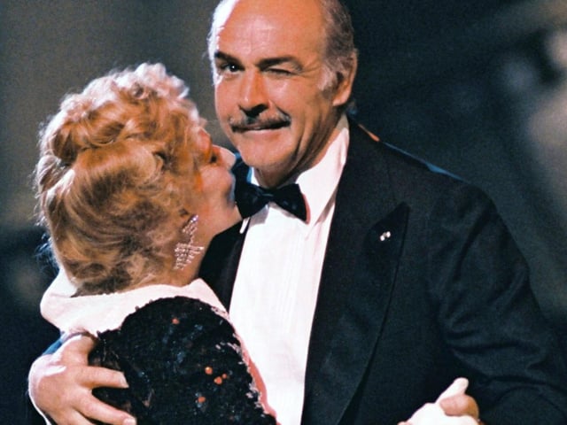 Scottish actor Sean Connery, President of 12th French Academy Cesar Awards, winks at the photographer while dancing 07 March 1987 in Paris witch French actress Jeanne Moreau, the annual French film Industry award ceremony. 