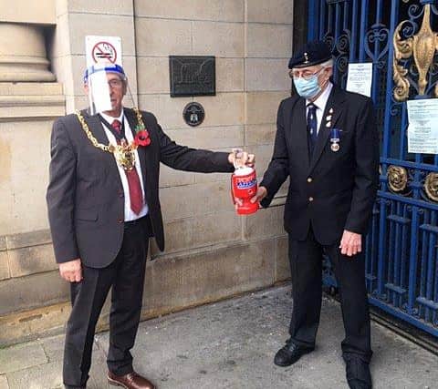 The Lord Mayor of Sheffield Tony Downing pictured buying a poppy from Bryan Green, chairman of the Sheffield group of the Royal British Legion