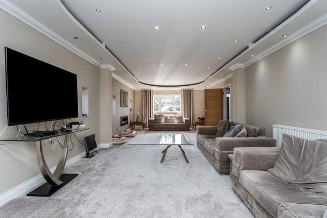 The extended living room has a recessed ceiling and spotlights. It also features four double glazed windows to the front and side aspects, and double glazed patio doors