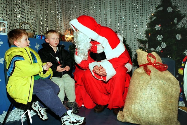 Santa in the Grotto at Shooters Grove Primary School, Wood Lane, Stannington, with pupils Richard Nettleship aged 4 (left) and Connor Barber aged 4, in December 1999