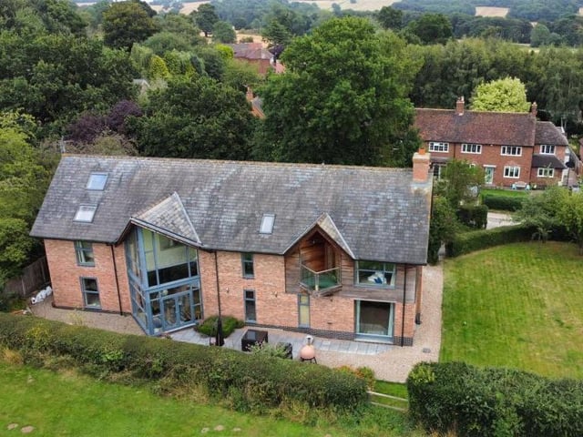 More drone footage, and clear evidence that the property fits in nicely with the landscape, surrounded by beautiful trees.