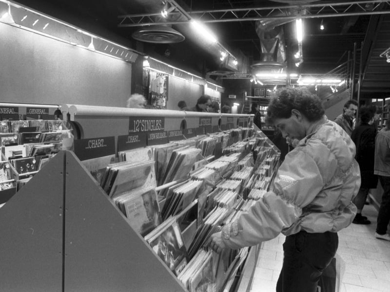 The Other Record Shop moved from the High Street to Princes Street in Edinburgh in December 1985. A man browses the 12" singles.