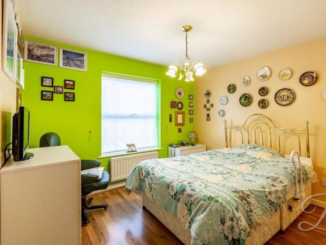 The second bedroom has built-in wardrobes, a central-heating radiator and a window to the front. It also has access to an en suite, which comprises a walk-in shower, pedestal wash basin and low-flush WC.