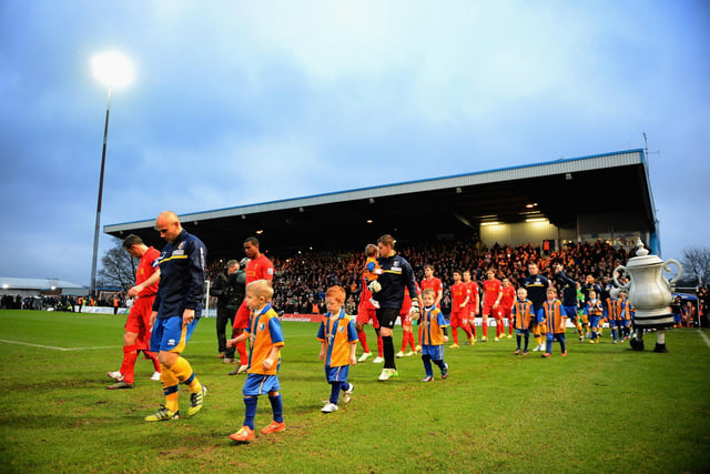 Adam Murray leads Mansfield out for the famous FA Cup third round match with Liverpool. Stags put in a brilliant performance before being cheated out of a replay by a Luis Suarez handball.