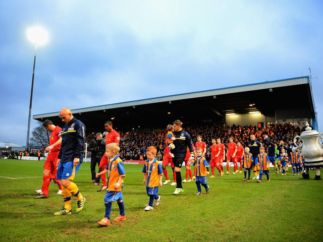Adam Murray leads Mansfield out for the famous FA Cup third round match with Liverpool. Stags put in a brilliant performance before being cheated out of a replay by a Luis Suarez handball.