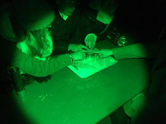 Summoning spirits the old fashioned way with a seance using a glass during a seance held at the Village in Mansfield.