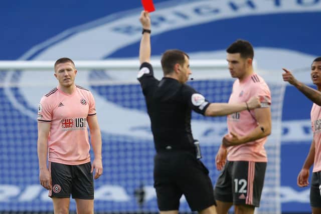 John Lundstram of Sheffield United (L) is sent off following a VAR review by referee Pater Bankes during the Premier League match at the AMEX Stadium: David Klein/Sportimage
