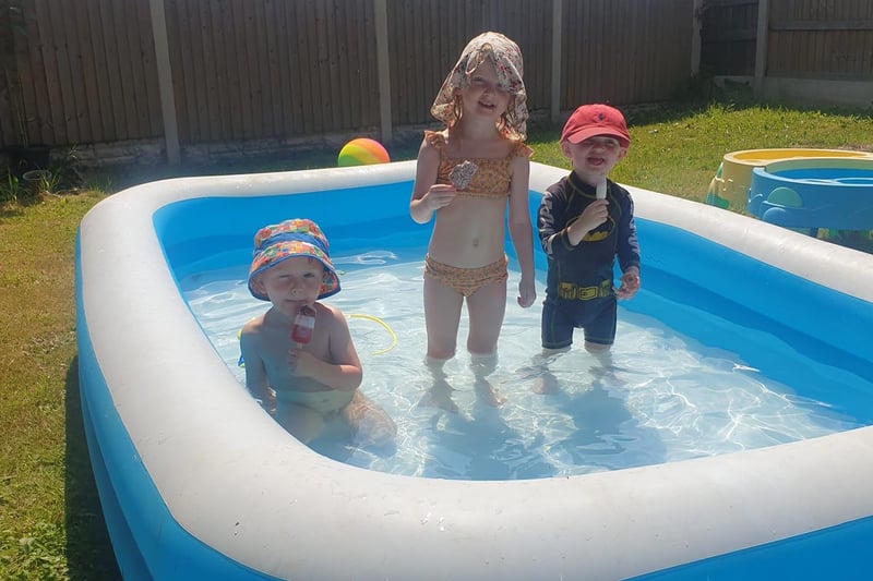 Finely, Harriet and Charlie enjoying ice cream in the paddling pool.
