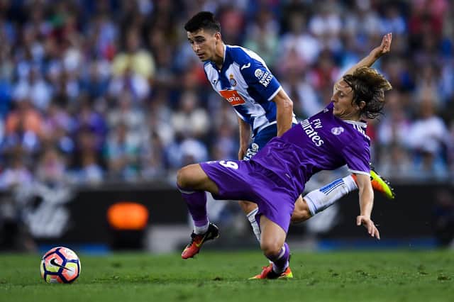 Luka Modric of Real Madrid CF competes for the ball with Marc Roca of RCD Espanyol (Photo by David Ramos/Getty Images)
