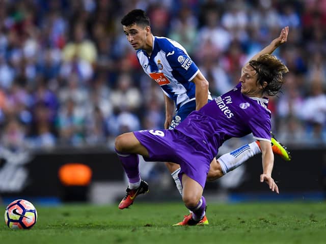 Luka Modric of Real Madrid CF competes for the ball with Marc Roca of RCD Espanyol (Photo by David Ramos/Getty Images)