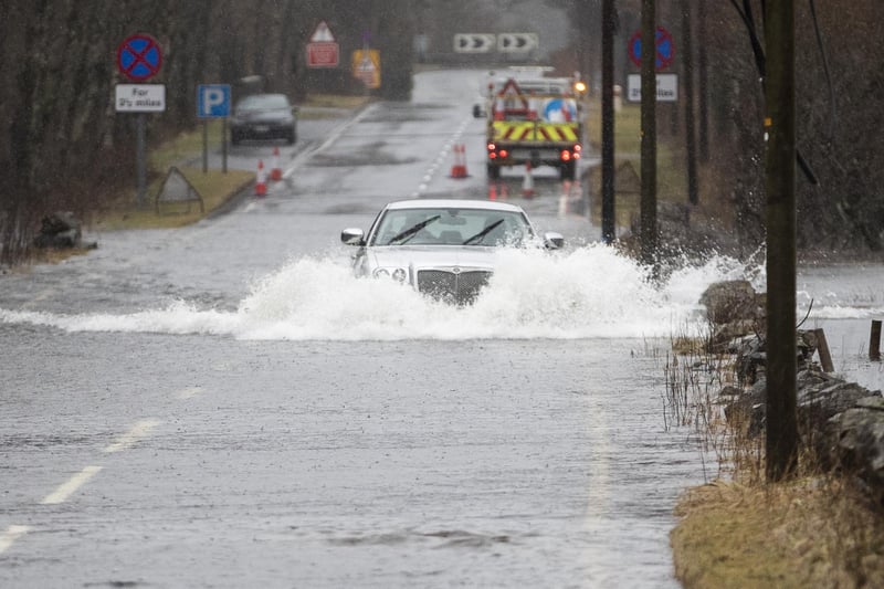 Motorists make their way through flood water along the A84 near Callander, Stirlingshire
