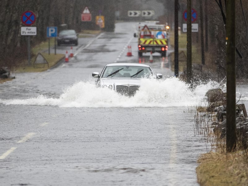 Motorists make their way through flood water along the A84 near Callander, Stirlingshire