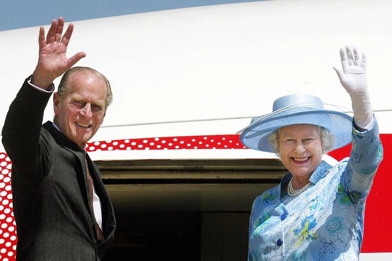 The Queen and Prince Philip wave goodbye as they board their plane at Abuja airport in Nigeria back in 2003 where the Queen addressed the Commonwealth Summit (Photo: AFP via Getty Images)