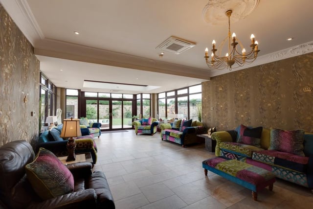 The orangery is very light and spacious, and benefits from underfloor heating and a decorative fireplace.