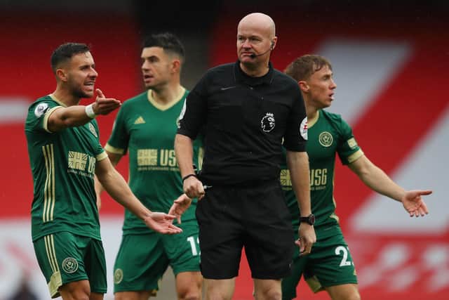 Referee Lee Mason ignores the Sheffiedl United players objections during the Premier League match at the Emirates Stadium, London.  Simon Bellis/Sportimage