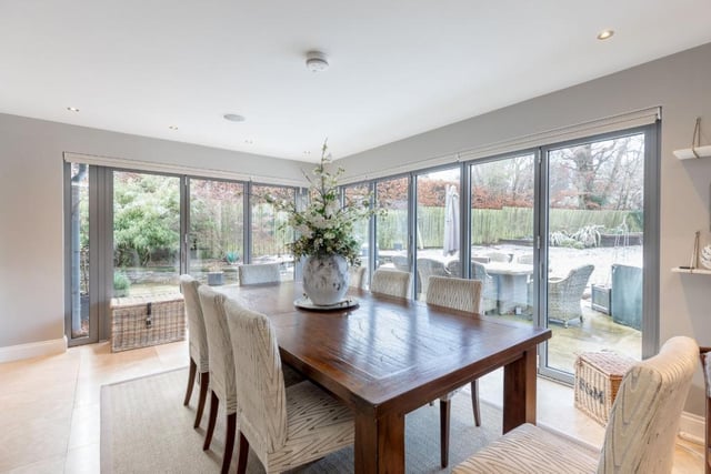 The dining room features bifold doors leading to the patio and garden.