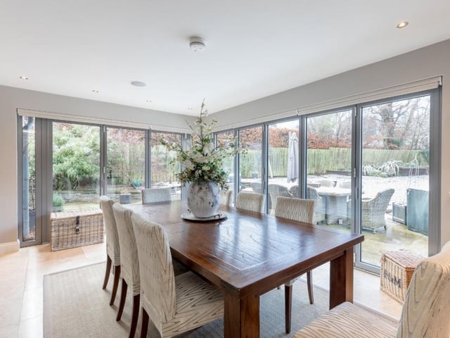 The dining room features bifold doors leading to the patio and garden.