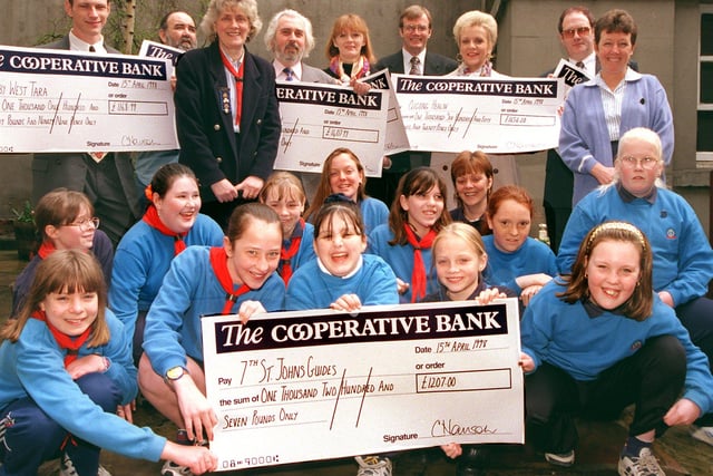 in 1998 Councillor Charles Harrison handed out several cheques from the Single Regeneration Budget to local organisations at the Mansion House, Doncaster. Our picture shows Councillor Harrison (back row, fourth from right) with the various recipients, including the 7th St John's Guides.