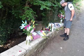Devasted friends and loved ones have today left tributes to a man found dead in water close a Sheffield estate. A friend is pictured looking at the flowers on the bridge, near the Shortbrook estate.