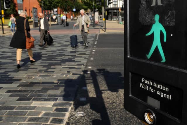 Pedestrians cross the road using a toucan crossing outside Sheffield train station. Picture: Andrew Roe