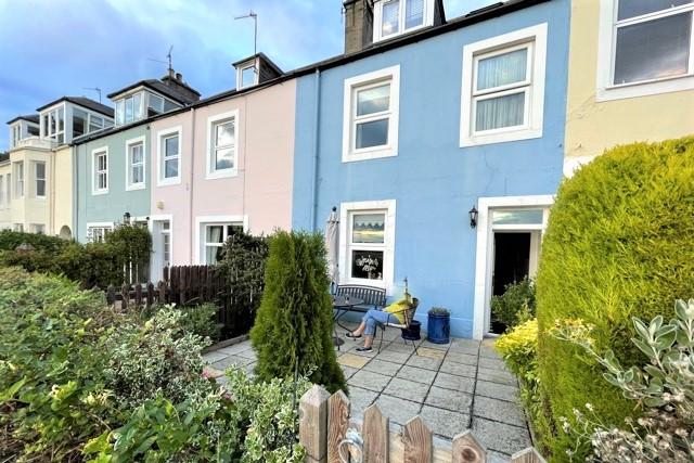 It has tremendous kerb appeal being painted bright blue, which contrasts perfectly with its neighbouring properties.