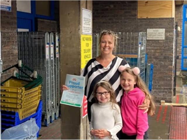 Sam Foster with her daughters at the hospital after her PPE donation.