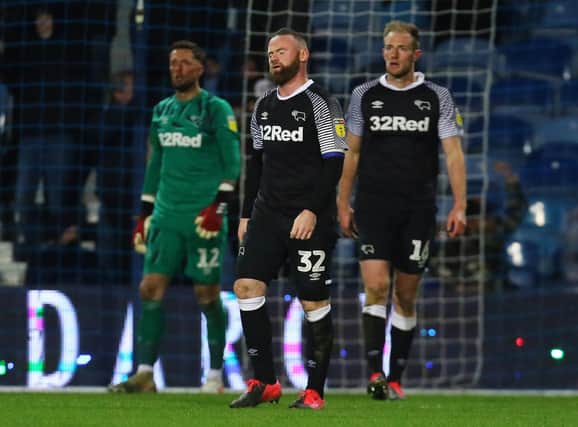 Derby County's Wayne Rooney looks dejected after QPR score their 2nd goal during the Sky Bet Championship match at Loftus Road, London. PA Photo.  Mark Kerton/PA Wire.