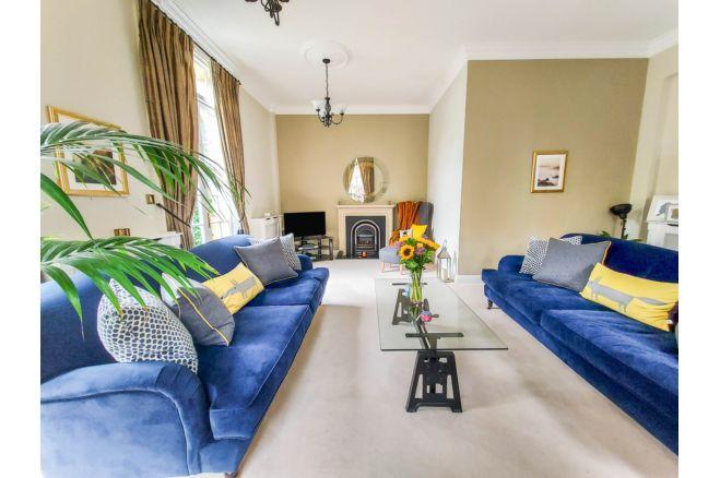 The lounge is described as elegant and is flooded with natural light from the two sets of floor to ceiling French doors. It also has two side facing sash windows.